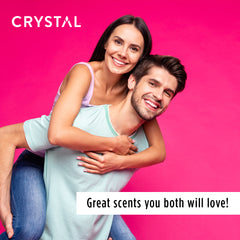Smiling couple on a bright pink background with Crystal branding for a deodorant campaign