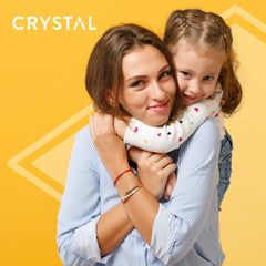 Mother and daughter embrace against a bright yellow background with Crystal branding