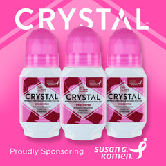 Three Crystal mineral enriched deodorant roll-ons with pink caps against a bright pink background supporting Susan G. Komen