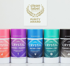 Assorted Crystal deodorants in pink purple blue teal and black with Purity Award badge above