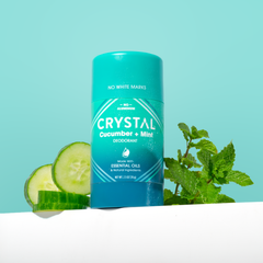 Crystal deodorant with pink cap against a teal background.