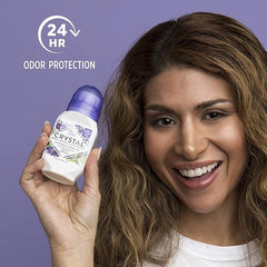 Smiling woman holding Crystal lavender mineral deodorant against a purple backdrop