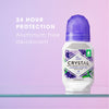 Crystal deodorant roll-on bottle with lavender and white tea scent on a purple background