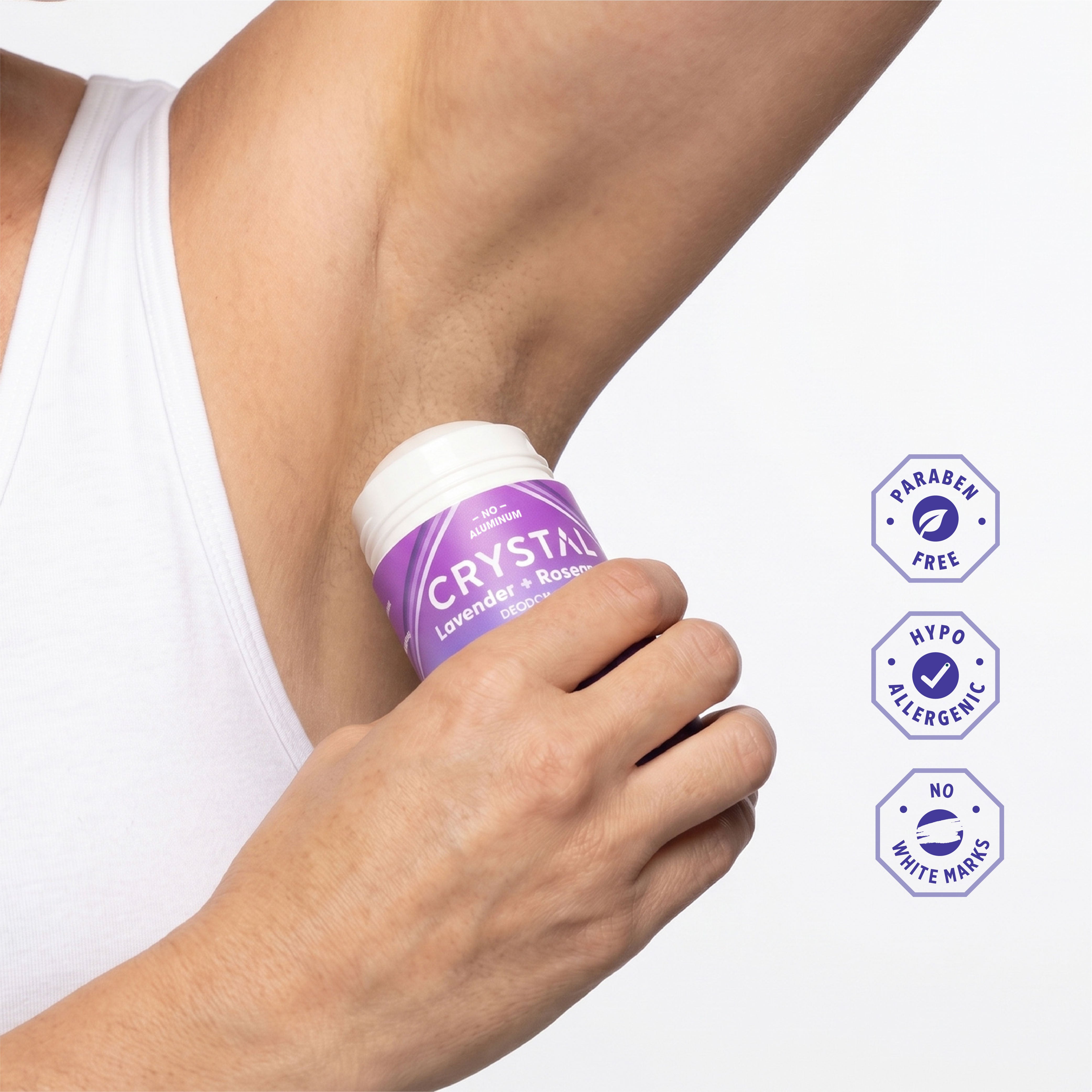 Person applying Crystal Lavender and Rosemary Magnesium stick deodorant on white background.