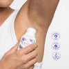 Person applying Crystl deodorant to their arm with product details on a white background