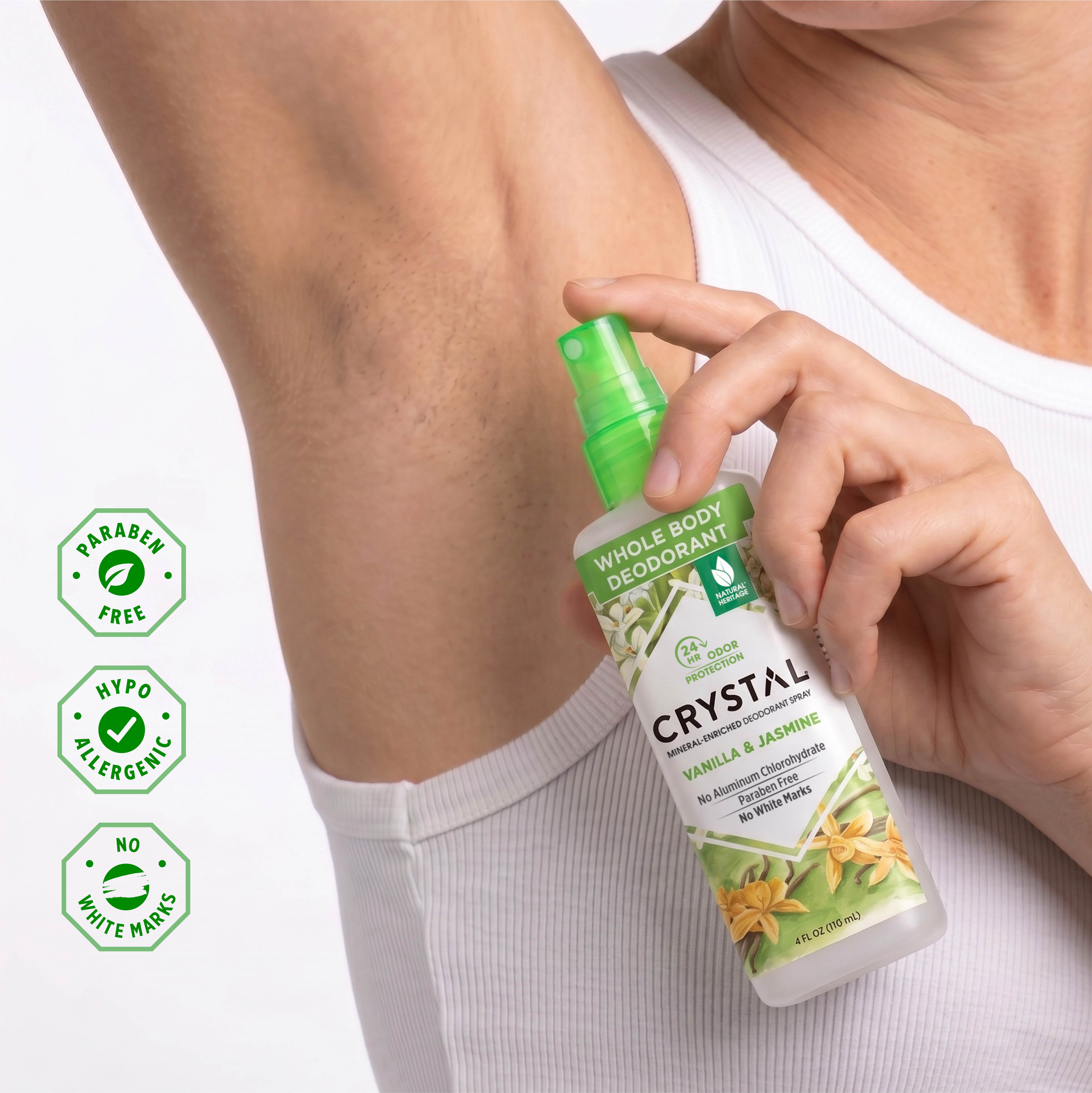 Person holding a bottle of Crystal Whole Body Deodorant with product details on a white background