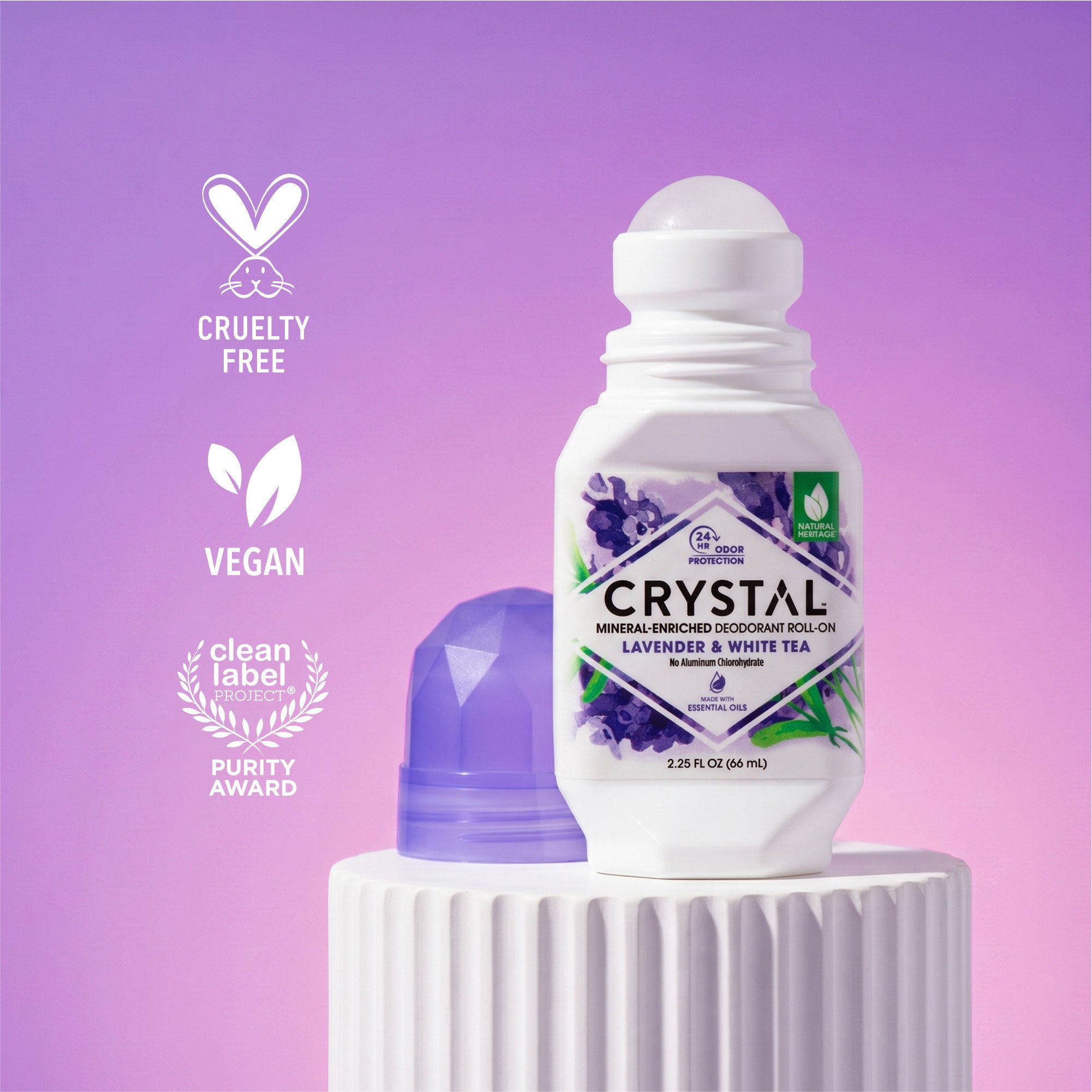 Crystal deodorant roll-on bottle with purple cap on a white pedestal against a purple background, featuring cruelty-free, vegan, and purity award icons.