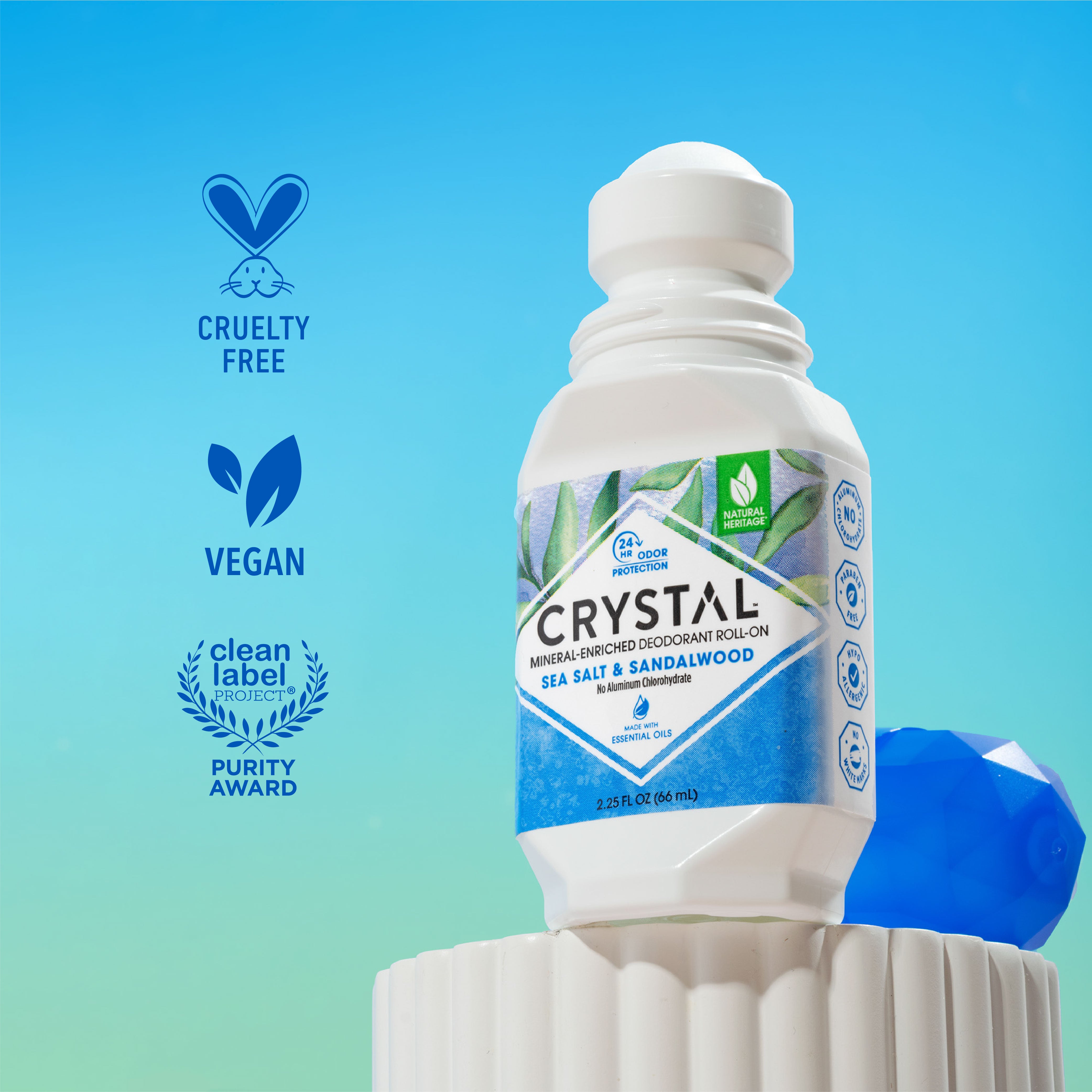 Crystal deodorant bottle with Sea Salt & Sandalwood scent on a blue and green gradient background.