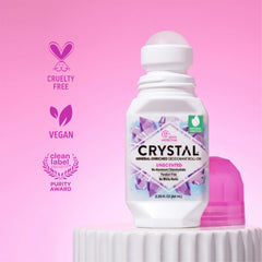 Crystal unscented deodorant roll-on bottle with pink background and certification logos.