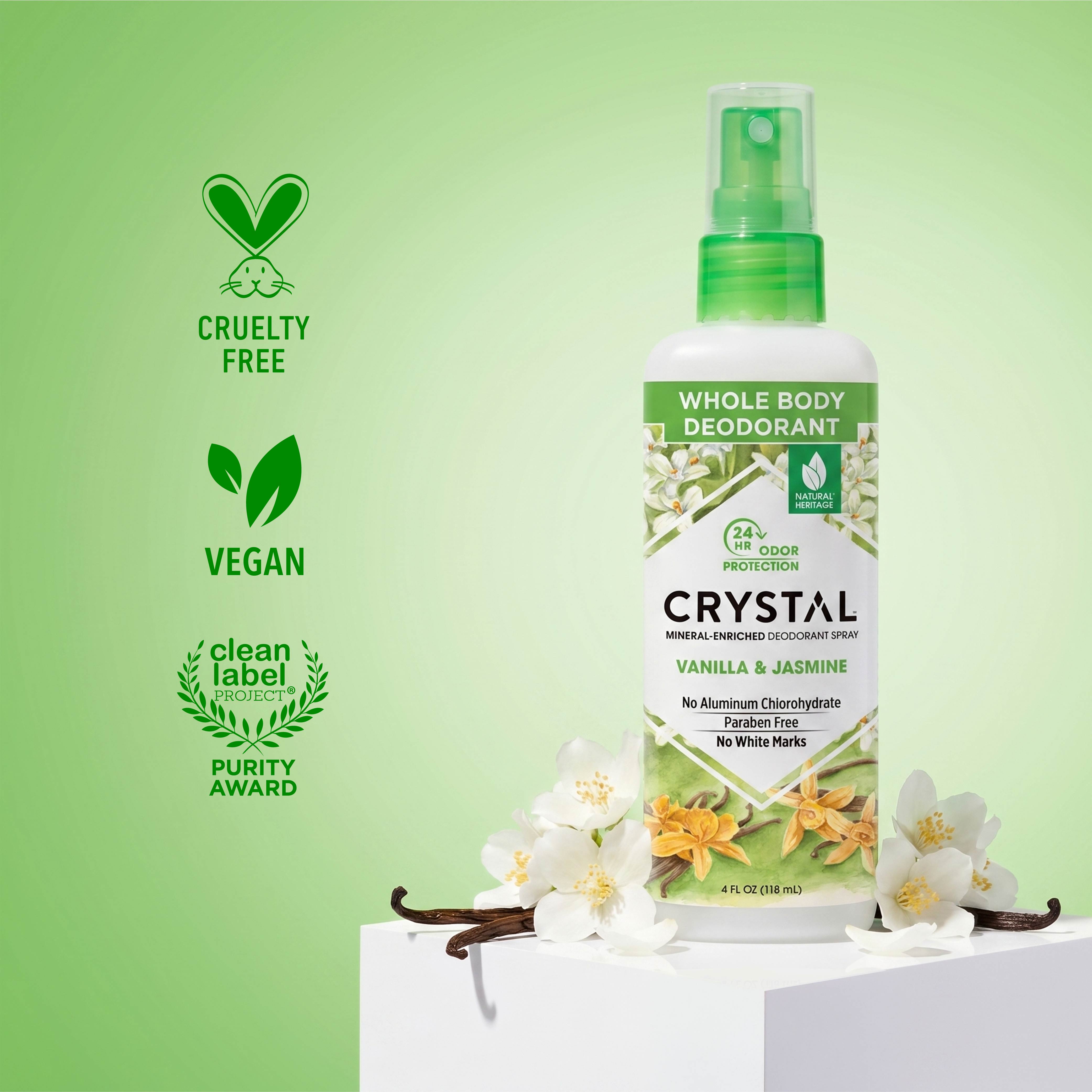 Crystal whole body deodorant bottle with vanilla and jasmine flowers on a green background