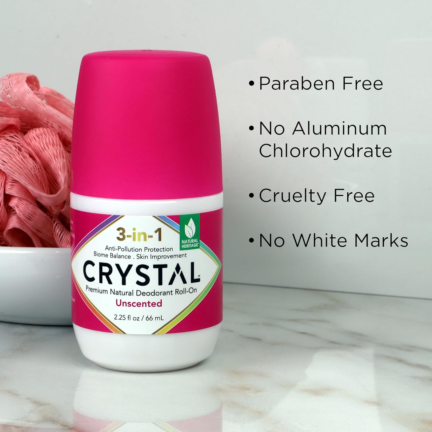 Pink and white Crystal deodorant roll-on with product features listed on a light background